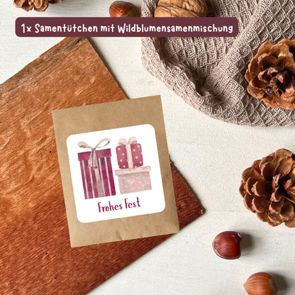 foodigence Samentütchen mit Wildblumensamen, winterlichen Geschenk-Illustrationen und dem Schriftzug „Frohes Fest“ als Adventskalender-Füllung und Weihnachtsgeschenk