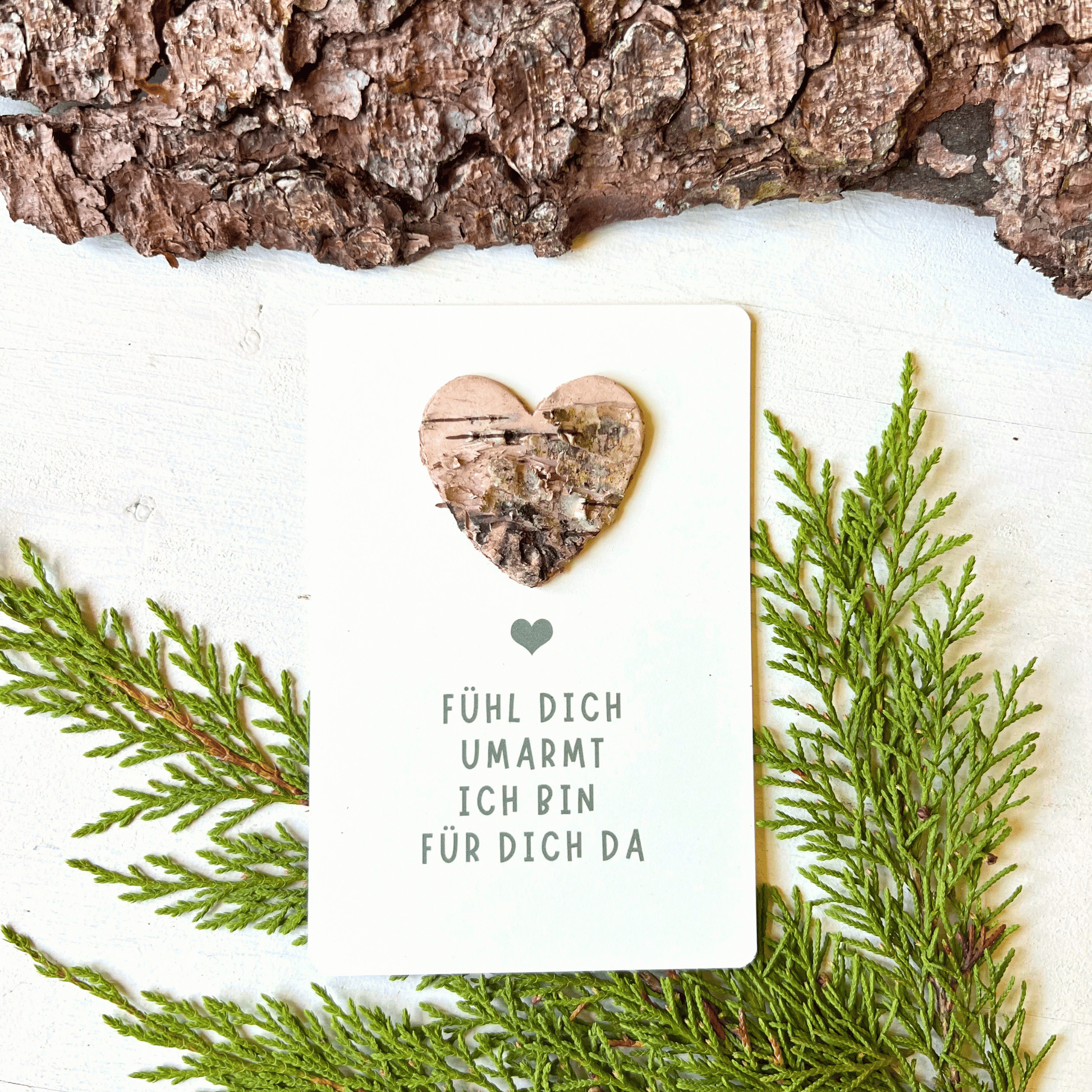 Postkarte mit Birkenherz "fühl dich umarmt - ich bin für dich da" vor Tannengrün